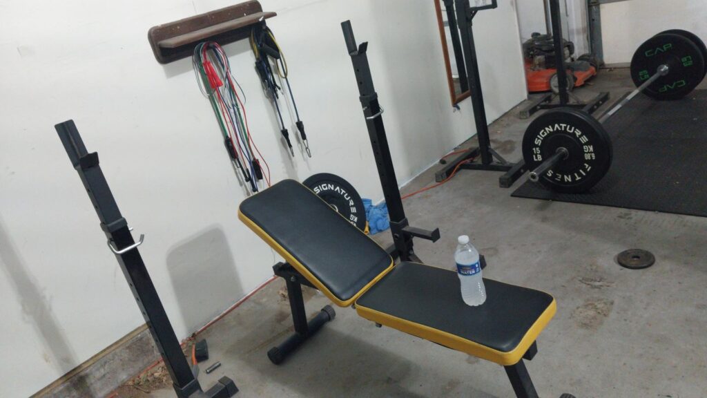 Home gym with bench squat racks and plates